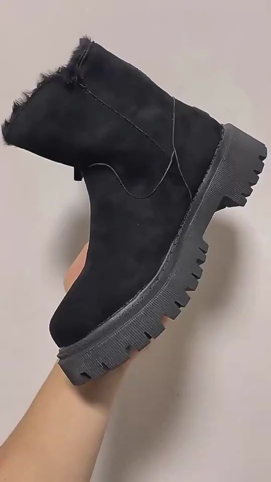 Video showcasing black suede ankle boots with a side zipper